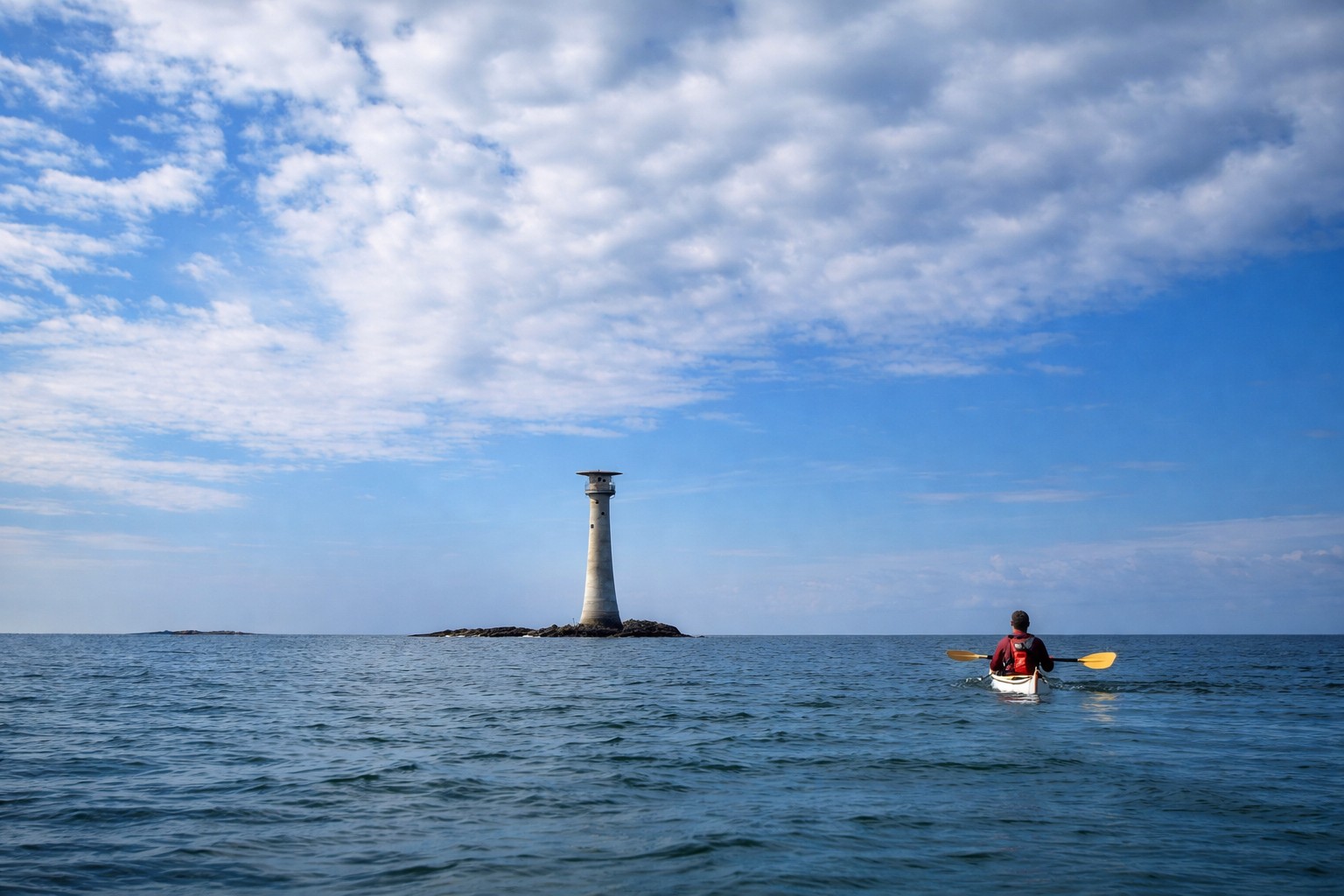 Sea kayak approaching the Smalls Lighthouse off Pembrokeshire