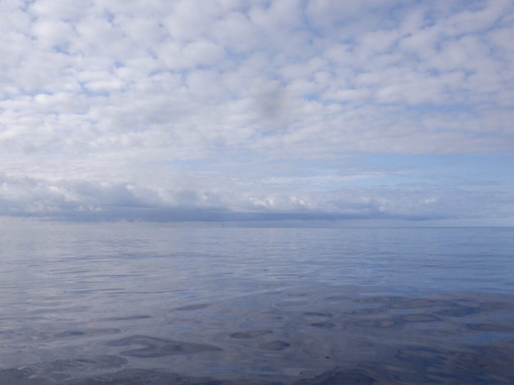 Sea kayak offshore near the Smalls Lighthouse with open Atlantic horizon