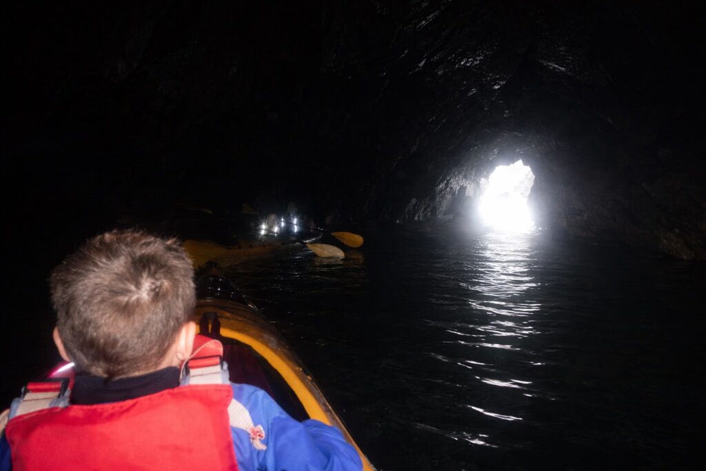 Sea kayak inside the dark room cave at the Witches Cauldron