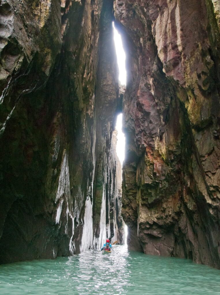 Sea kayak inside the Huntsman's Leap in Pembrokeshire.