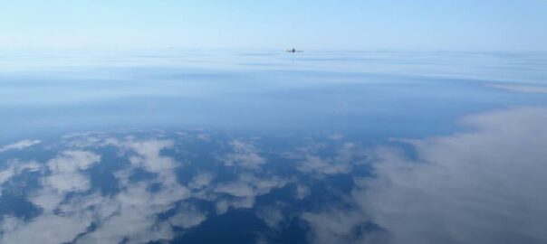 Sea kayak mid-crossing on the Irish Sea under open horizon