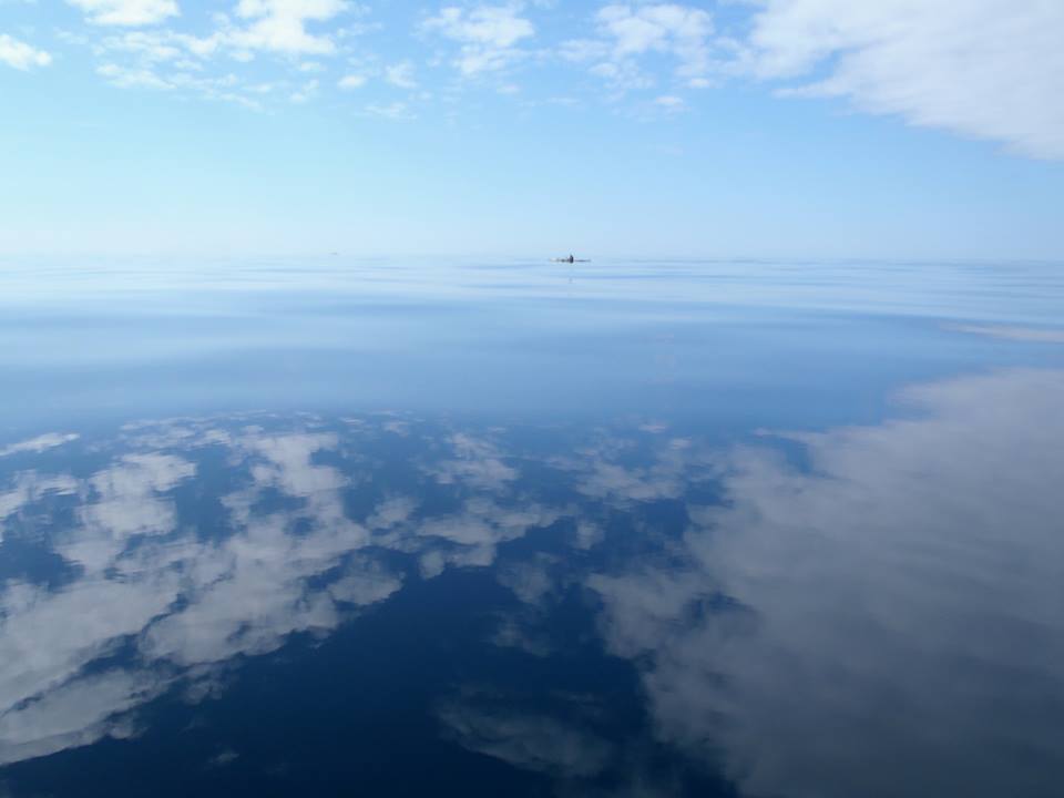 Sea kayak mid-crossing on the Irish Sea under open horizon