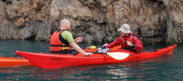 Instructor coaching sea kayaking technique during a course in Pembrokeshire