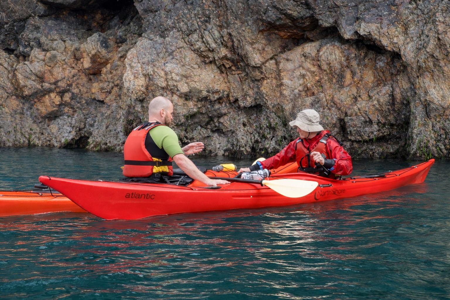 Instructor coaching sea kayaking technique during a course in Pembrokeshire