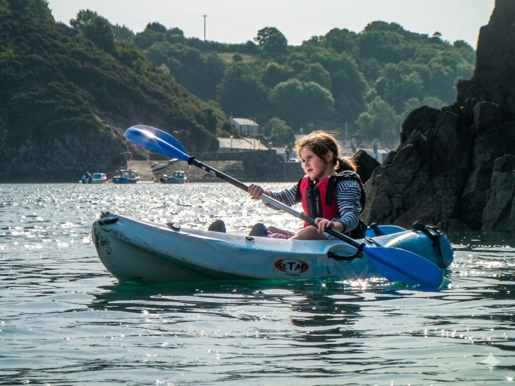 Beginner paddler using a sit on top kayak