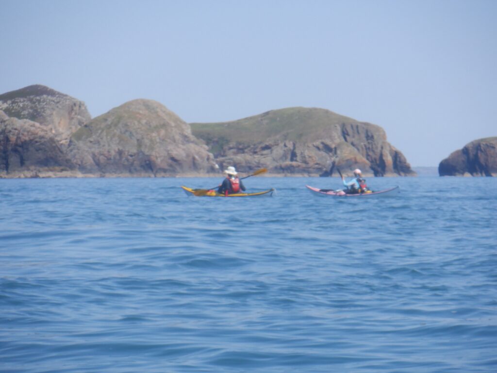 Sea kayakers paddling around Ramsey Island in Pembrokeshire