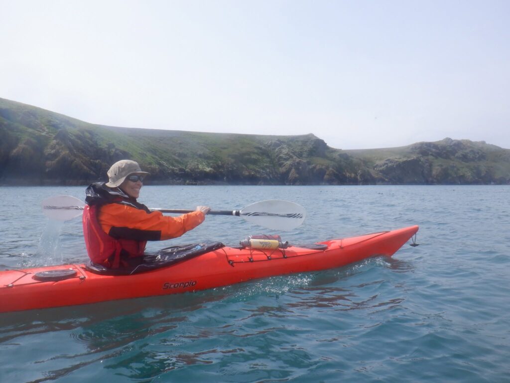 Sea kayakers exploring the coastline of Skomer Island from the water