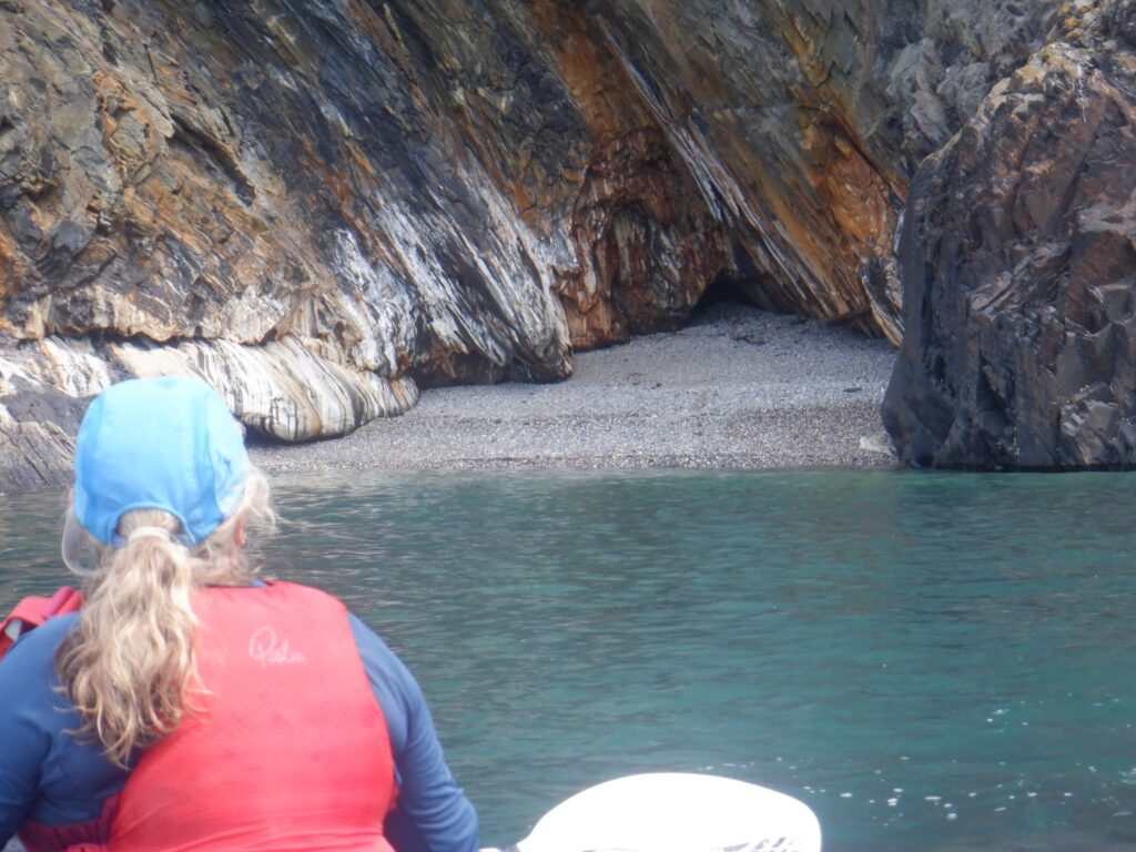 Sea kayaker watching wildlife from a kayak off the Pembrokeshire coast
